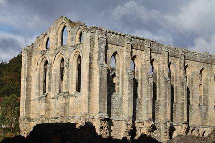 A stone building with many windows
Description automatically generated